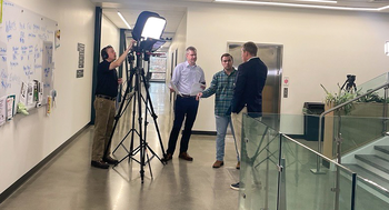 A small video crew films an interview