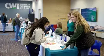 Students receive guidance from another student at a student recource fair.