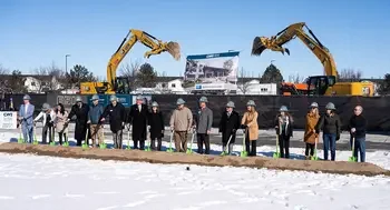 Dignitaries stand with shovels for a ceremonial groundbreaking.