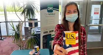 Student holding a mini constitution