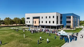 Aerial view of people gathered for an outdoor ribbon-cutting event