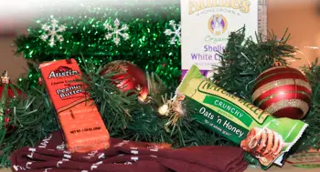Food, socks, and ornaments surrounding a Christmas tree.