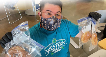 Staff member handing out donuts and bagels the first week of classes