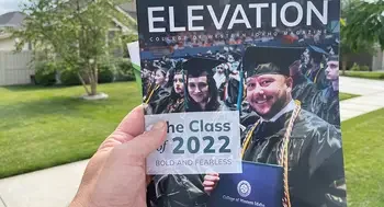 Individual holding a copy of Elevation outside