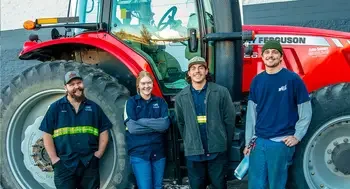 Heavy Equipment Technician students standing in front of tractor