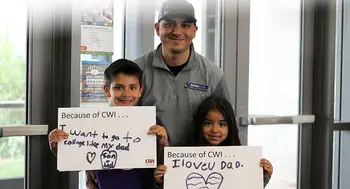 Students holding up their Because of CWI signs