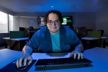 Student sitting at a computer in a classroom