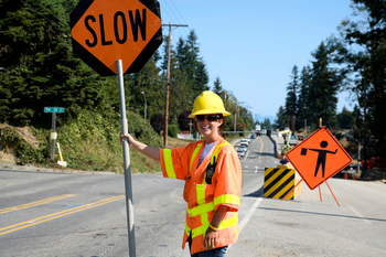 Person with slow sign standing in the street