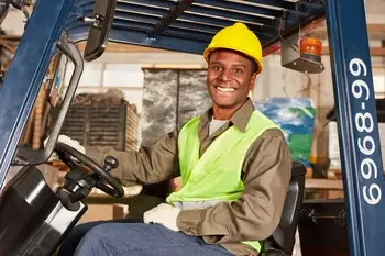 Student learning how to drive a forklift