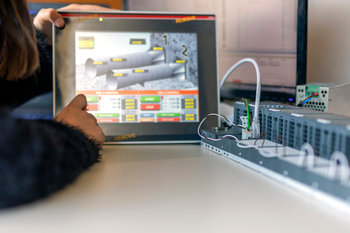 Close up of student touching controls on tablet