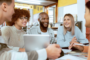Students talking and working together at a table