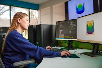 Software development student working at a computer.