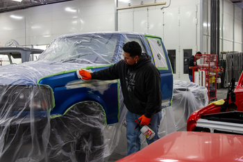 CWI Student sanding and cleaning Bondo on the body of a vehicle