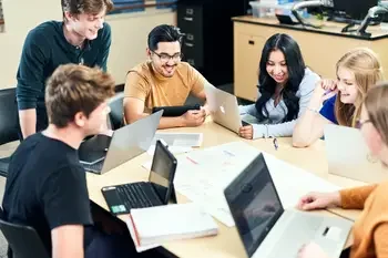 Group of students working with a teacher.