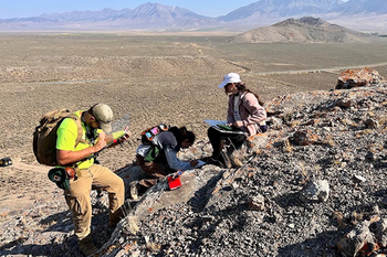 Students with studing rocks formations outside