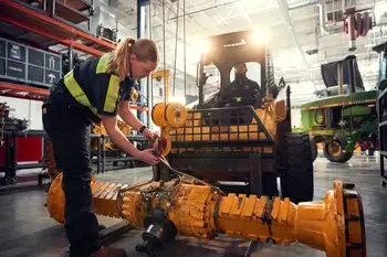 Students working on a piece of heavy equipment.