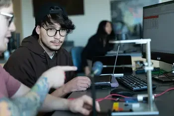Students in a classroom looking at equipment