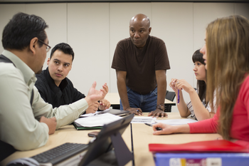 Table of CWI students having a conversation