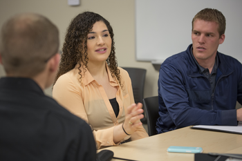 Management students having a discussion in classroom