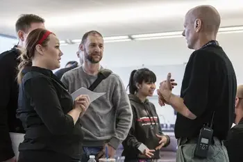 Group of students talking to an officer in a classroom