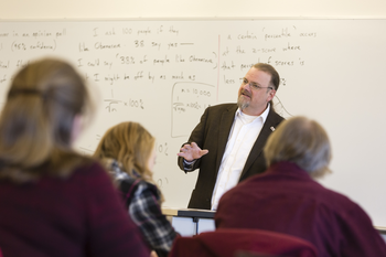 Sociology instructor presenting to room full of students