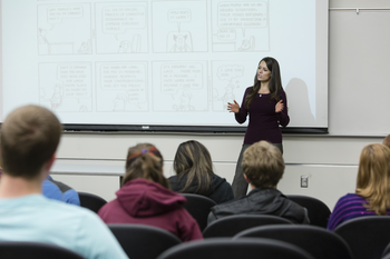 Instructor giving a lecture in-front students in classroom