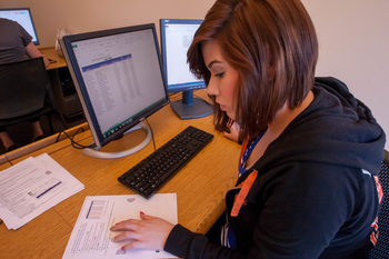Student studying at computer in classroom