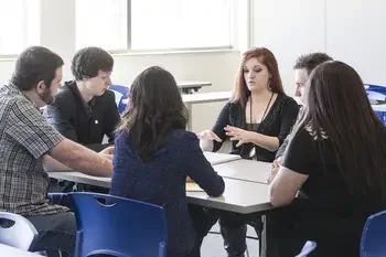 Group of CWI students talking at a table