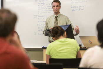 Spanish instructor presenting in front of students in classroom