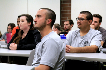 Students sitting at tables in a classroom