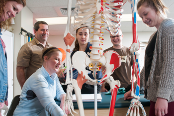 Group of students around instructor in lab