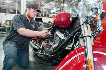 Student working on motorcycle