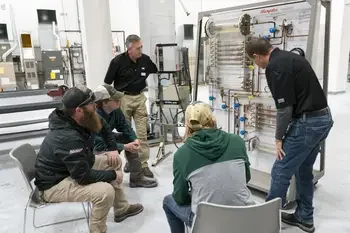 Instructor showing group of students components on an HVAC system