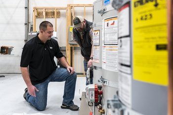 Plumbing students working on water heaters