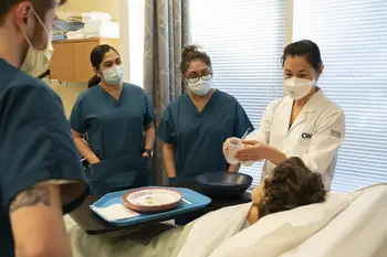 Instructor demonstrating techniques to help patients to group of students
