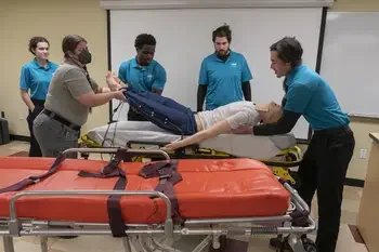 CWI students lifting mannequin