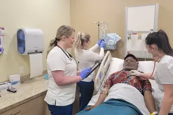 Three students monitoring patients vitals in healthcare lab
