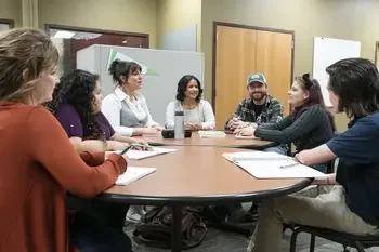Group of students talking at a table