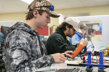 Students in classroom with electronic equipment