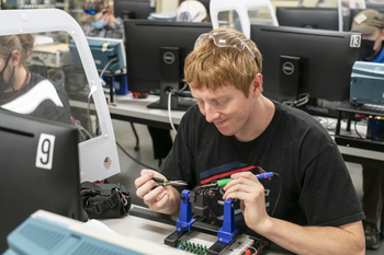 CWI student using electronics equipment