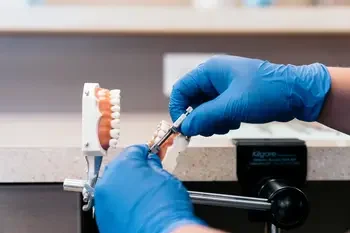 Hands working on a teeth mold