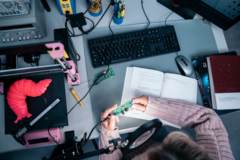 Looking down on a student studying equipment