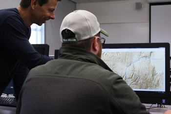 Geographic Information Systems students looking at map on computer.