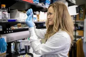 Student examining test tube.
