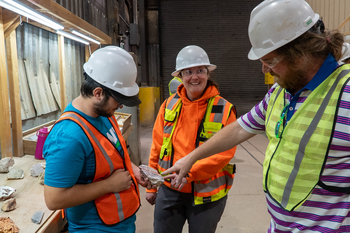 Mining students examining a core sample.