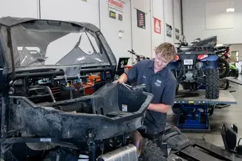 Student working on side by side in Powersports and Small Engine Repair Lab