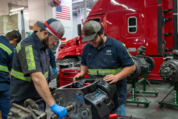 Two CWI Students working on a truck transmission