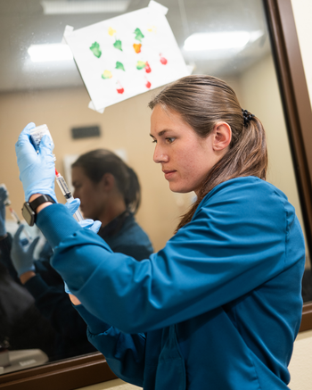 Nurse measuring out medicine for an injection
