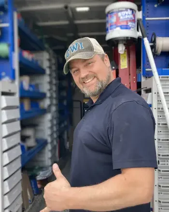 Happy person standing in front of work van