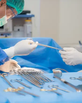 Surgical Technologists working with tools in an operating room